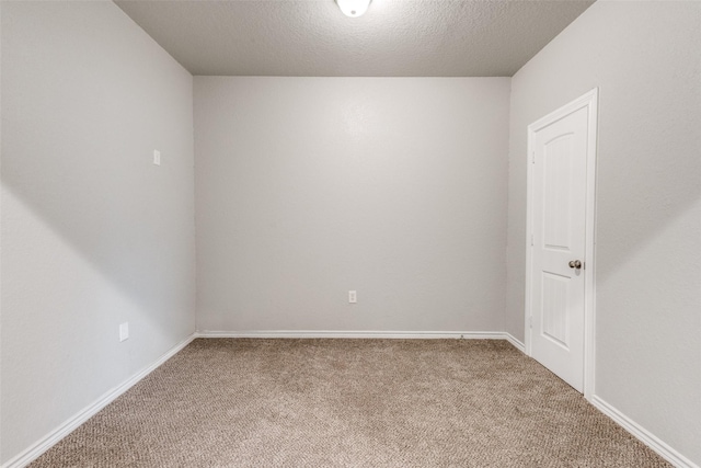 unfurnished room with carpet floors and a textured ceiling