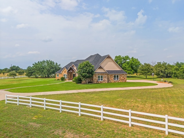 view of front of property with a front lawn and a rural view