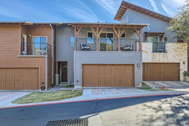 view of front of property with a balcony and a garage