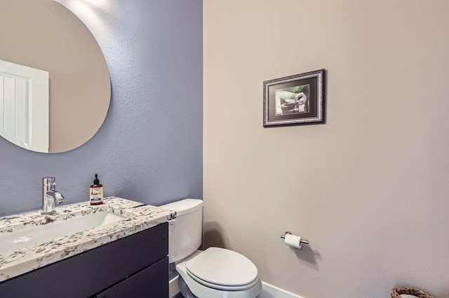 bathroom with toilet and vanity