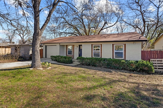 ranch-style home featuring a front yard and a garage