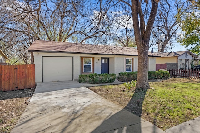 ranch-style home with a front lawn and a garage