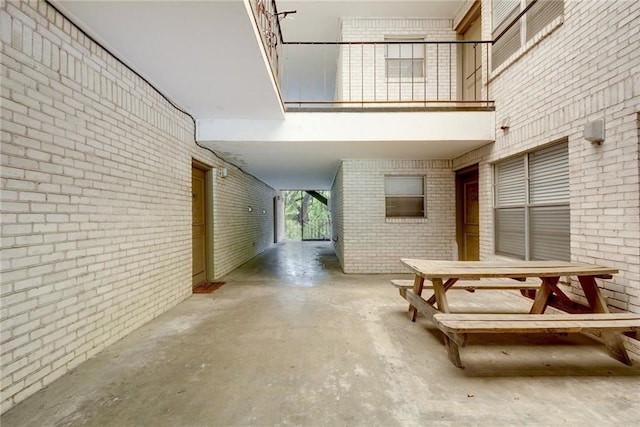 710 E Dean Keeton St Unit 210, Austin, TX 78705 - hallway with brick wall, unfinished concrete floors, and a towering ceiling