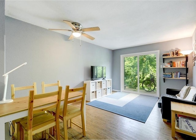 living room featuring ceiling fan and hardwood / wood-style flooring