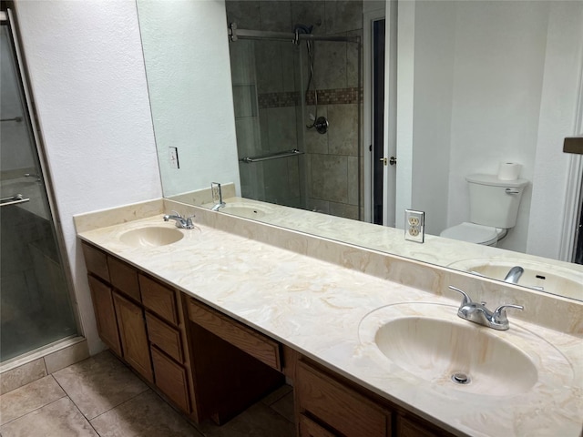 bathroom with a shower with door, toilet, tile patterned flooring, and vanity