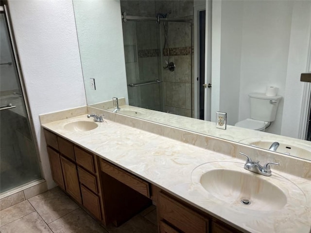 8200 Neely Dr Unit 117, Austin, TX 78759 - bathroom with double vanity, a shower stall, toilet, and tile patterned floors