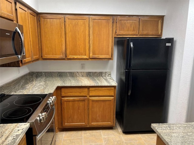 8200 Neely Dr Unit 117, Austin, TX 78759 - kitchen with stainless steel appliances, brown cabinets, and light stone countertops