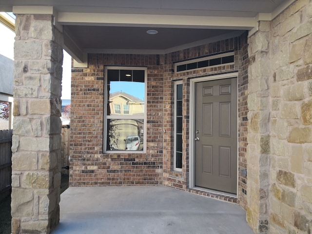 view of exterior entry with a porch