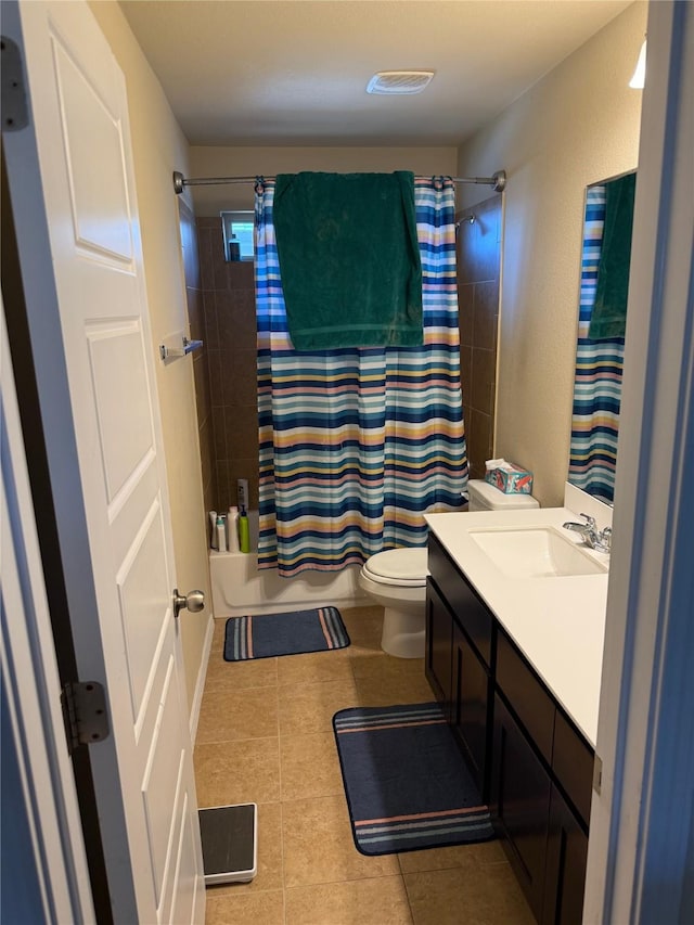 full bathroom featuring tile patterned floors, toilet, vanity, and shower / bathtub combination with curtain