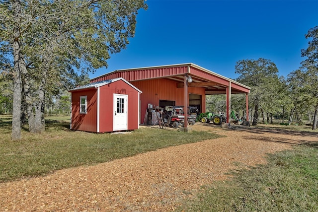 view of outbuilding featuring a lawn