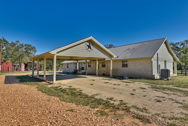 exterior space featuring central AC unit and a carport