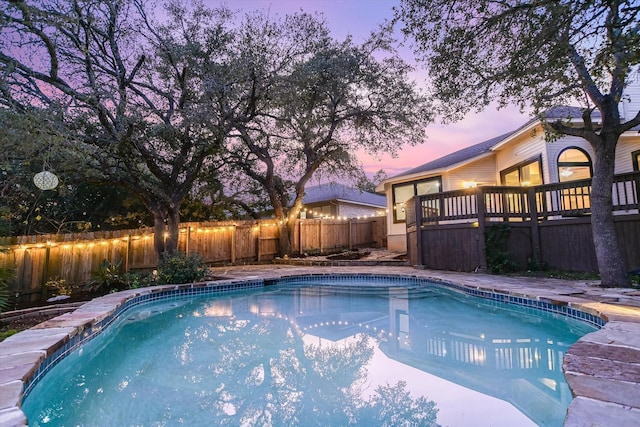 view of pool at dusk