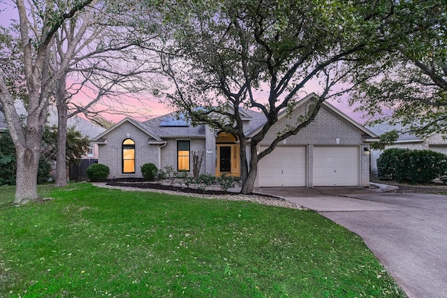 view of front facade with a lawn and a garage