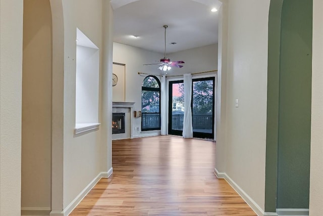 6817 Beatty Dr, Austin, TX 78749 - hall featuring light wood finished floors and arched walkways