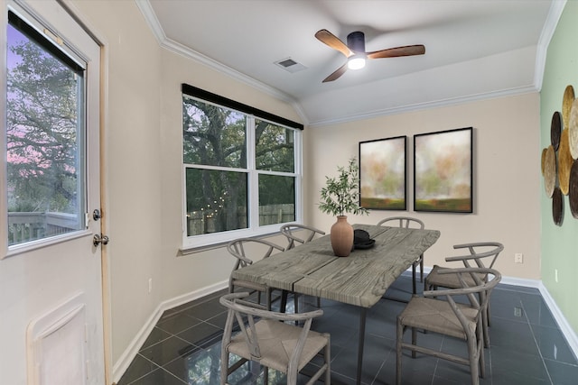 tiled dining space with ceiling fan, ornamental molding, and lofted ceiling