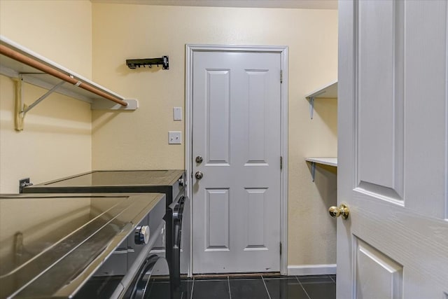 6817 Beatty Dr, Austin, TX 78749 - laundry room featuring dark tile patterned flooring and baseboards