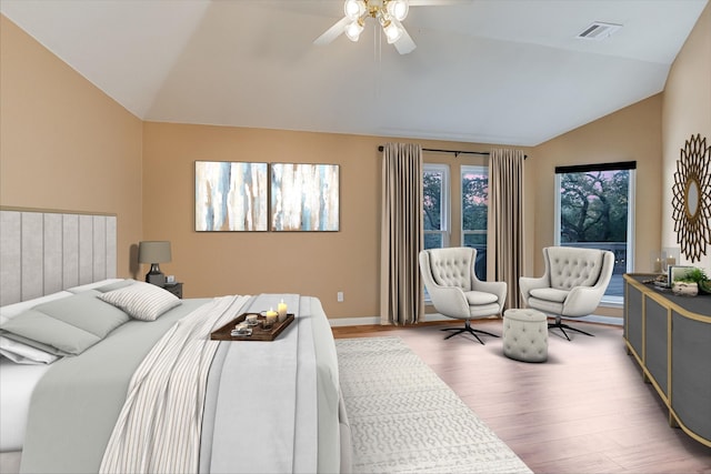 bedroom with vaulted ceiling, ceiling fan, and wood-type flooring