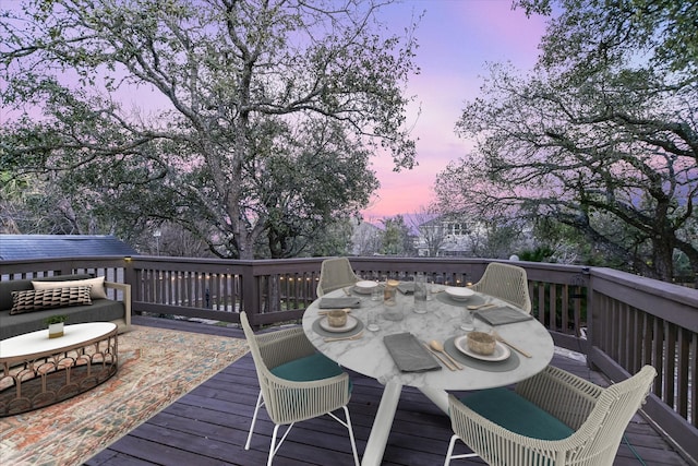 deck at dusk featuring an outdoor living space