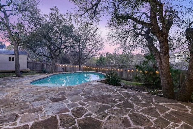 6817 Beatty Dr, Austin, TX 78749 - view of swimming pool featuring a fenced backyard, a patio area, and a shed