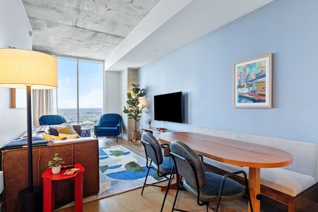 office area with light wood-type flooring and floor to ceiling windows