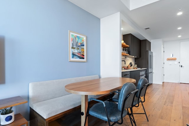 dining space featuring light hardwood / wood-style floors and sink