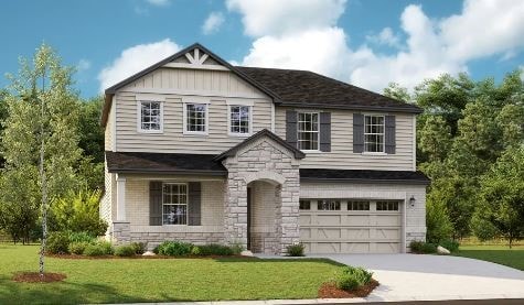 view of front of home with a garage and a front lawn