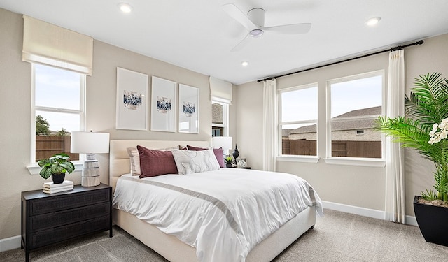 bedroom featuring multiple windows, ceiling fan, and carpet