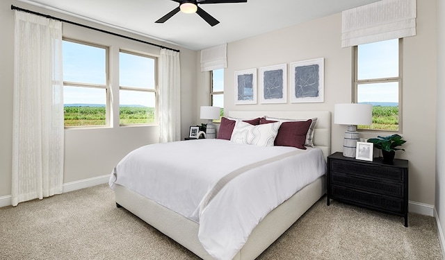 bedroom with light carpet and ceiling fan