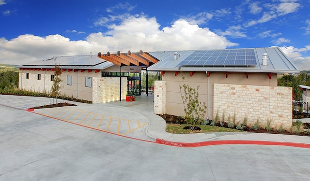 17101 Astral Ln, Manor, TX 78653 - view of home's exterior with roof mounted solar panels and stucco siding