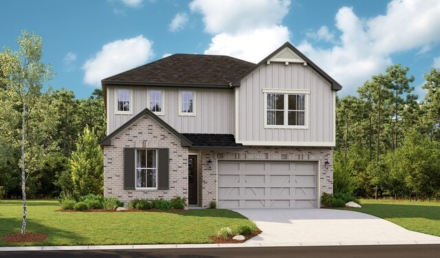 view of front of house with a garage and a front yard