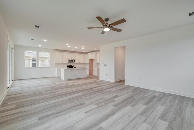 17109 Astral Ln, Manor, TX 78653 - unfurnished living room with ceiling fan, light wood-type flooring, and recessed lighting