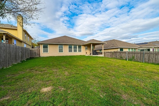 rear view of property featuring a yard and a patio area