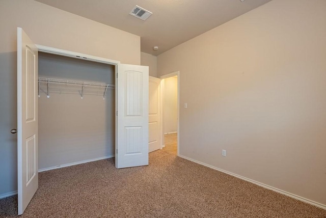 unfurnished bedroom with carpet floors and a closet