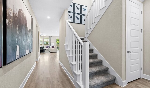 staircase with wood-type flooring