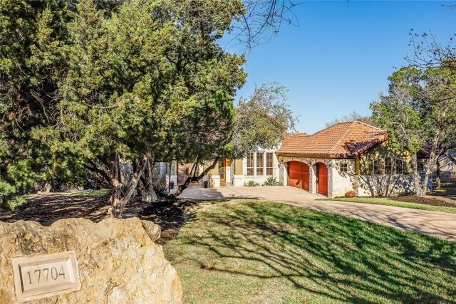 view of front of home with a front yard and a garage