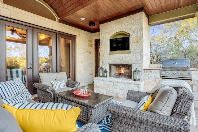 view of patio featuring a grill and an outdoor living space with a fireplace