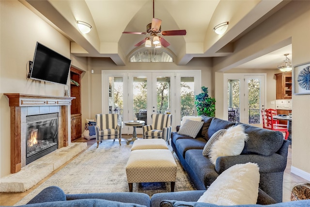 living room with ceiling fan, french doors, and a fireplace