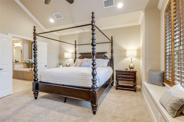 bedroom featuring crown molding, light carpet, ensuite bathroom, and lofted ceiling