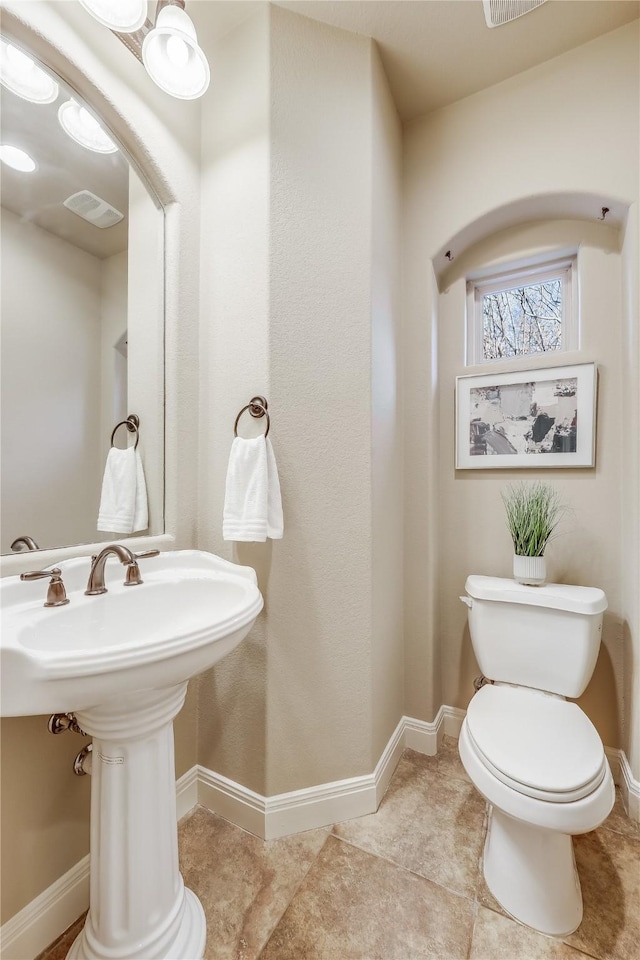 bathroom featuring tile patterned floors and toilet