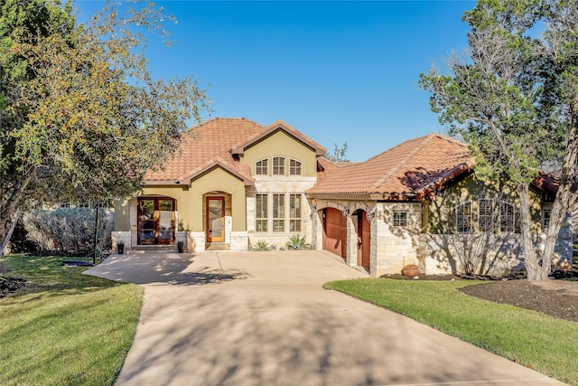 mediterranean / spanish-style house with a garage and a front yard