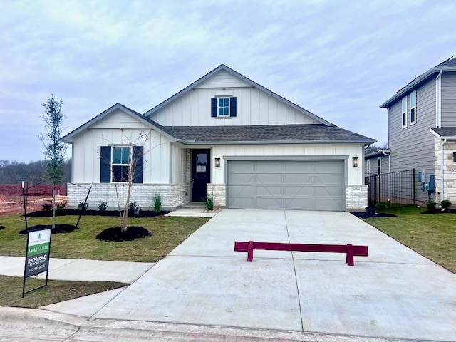 view of front of property with a garage and a front lawn