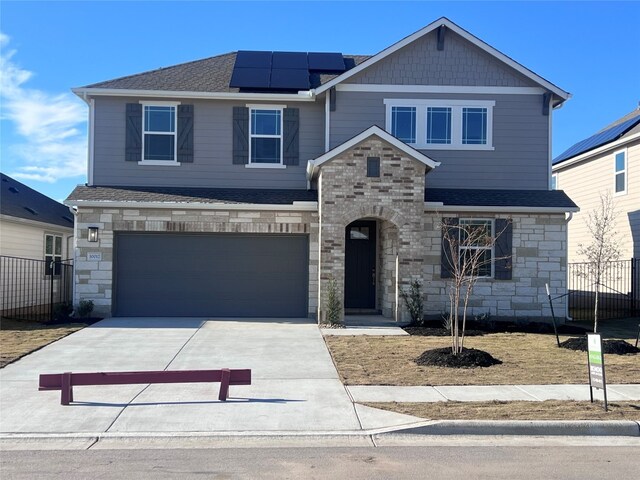 view of front facade with solar panels and a garage