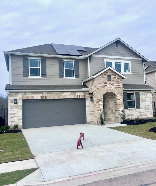 view of front facade with solar panels and a garage