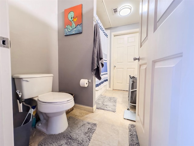 bathroom featuring toilet and tile patterned flooring