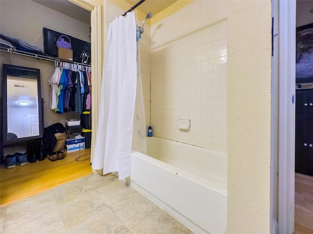 bathroom featuring shower / bathtub combination with curtain and wood-type flooring