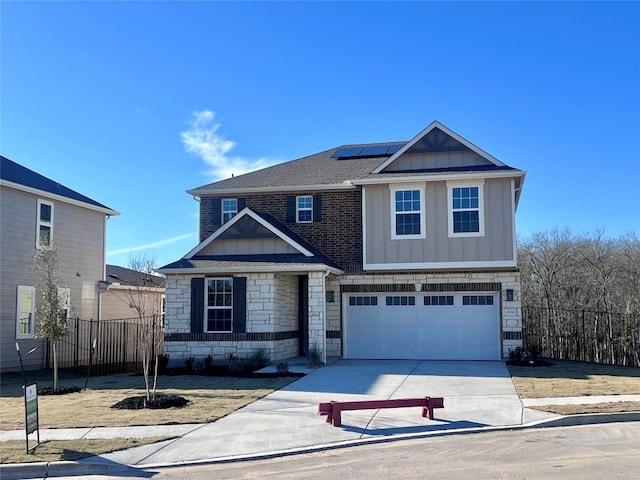 view of front of house featuring a garage and solar panels