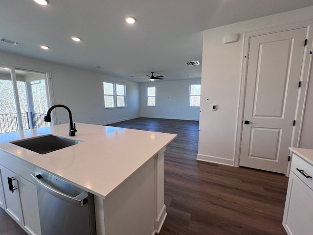 kitchen with dishwasher, sink, a center island with sink, and white cabinets