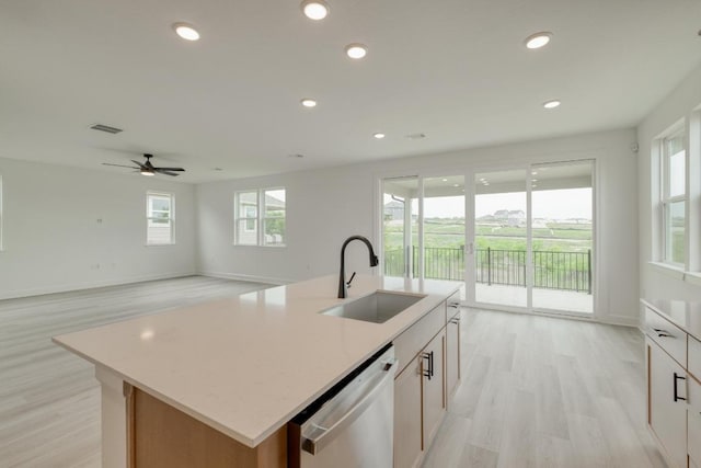 17108 Vernal Rd, Manor, TX 78653 - kitchen with dishwasher, light wood-type flooring, a center island with sink, recessed lighting, and ceiling fan
