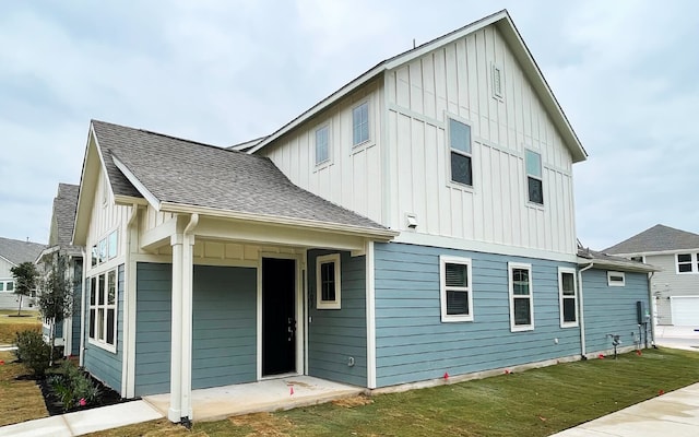 rear view of house featuring a yard