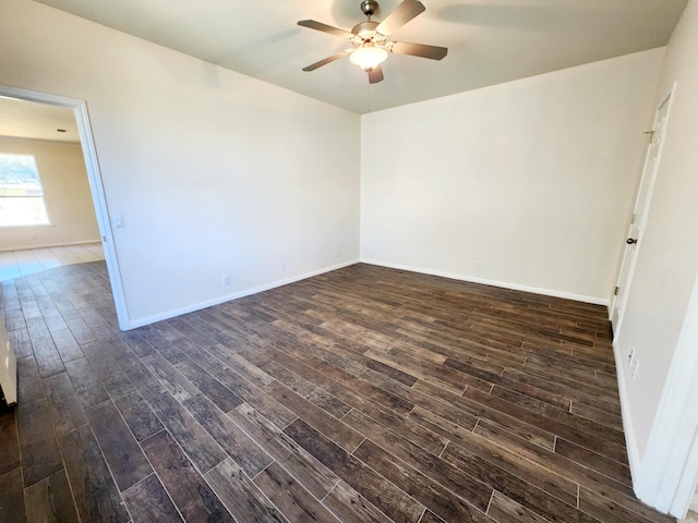 spare room with ceiling fan and dark hardwood / wood-style floors